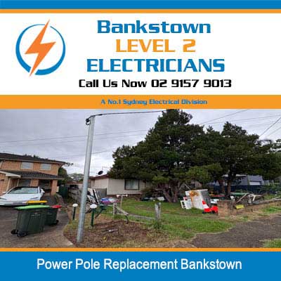 Power pole replacement in residential street with houses and overhead electrical lines in Bankstown